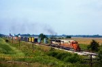 IC, Illinois Central SD40-2 6002-GM&O GP30 510, northbound and about to duck under I-57, at Tonti, Illinois. September 5, 1980.